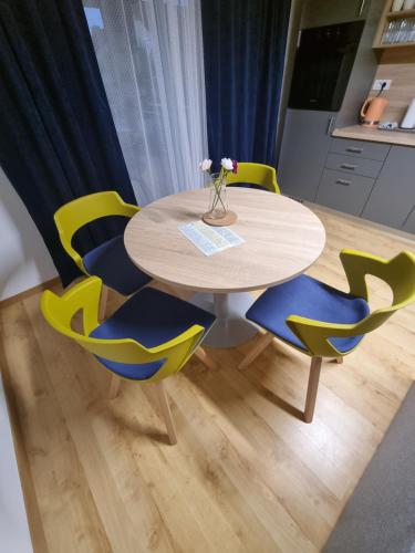 a table with four chairs and a table with flowers on it at KFN Concept One in Zagreb