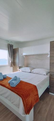 a bedroom with two beds with towels on them at Mobile home Greta in Klenovica