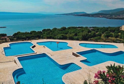 a pool with a view of the water at Mobile home Greta in Klenovica
