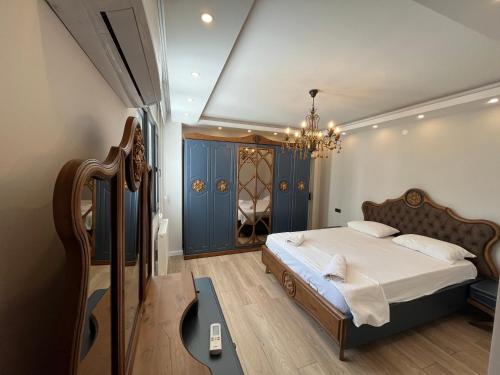 a bedroom with a bed and a chandelier at Reis apart in Trabzon