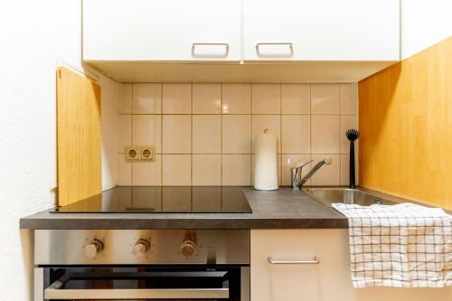 a kitchen with a sink and a counter top at Work & Stay Apartment 2 rooms in Pohlheim