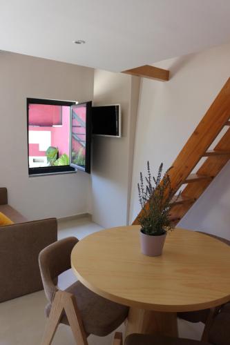 a dining room with a wooden table and chairs at Casas da Corujeira in Porto