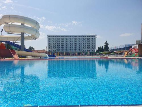a large swimming pool with a water slide at De Lux Nedeljkovic in Jagodina