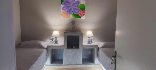 a room with two beds and a table with two lamps at FILINA's luxury house in Maltezana