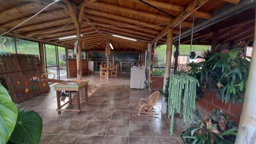 a large room with a table and some plants at Casa de Campo vía El Peñol Guatapé in Marinilla