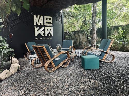 a group of chairs sitting in front of a sign at Maka Hotel Boutique in Tulum