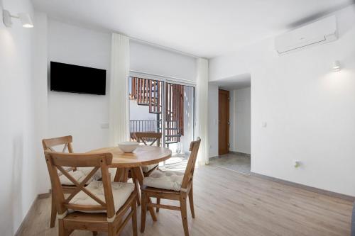 a dining room with a wooden table and chairs at Old Town Apartments Sea View in Lagos