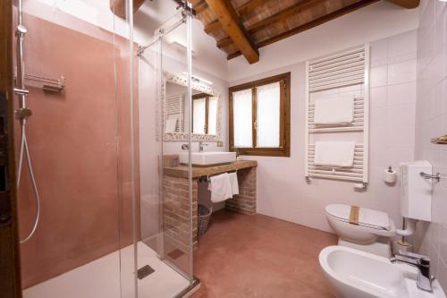 a bathroom with a shower and a toilet and a sink at La Tenuta Va Oltre in Bovolenta