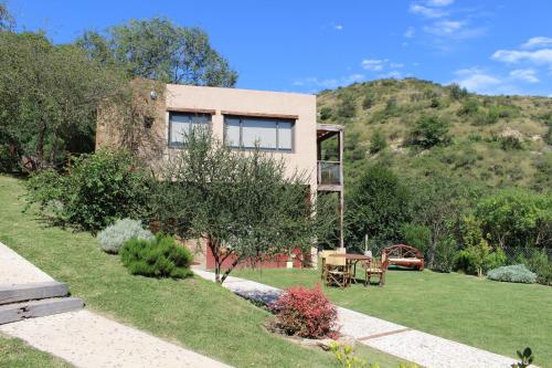a house on a hill with a grass yard at Moradillo Apart in La Cuesta