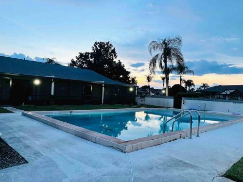 a large swimming pool in a yard with a house at Modern Sun N’ Lake Villa - Self Check-In in Sebring