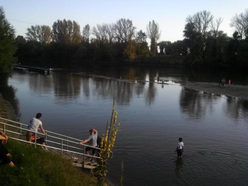 a group of people standing on a bridge over a river at Szép-Lak Makó in Makó