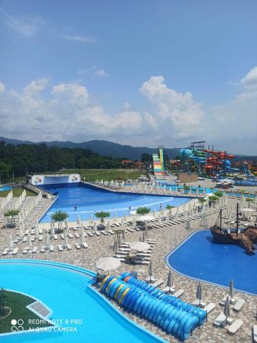 a group of pools with umbrellas and water slides at Apartman Splendid in Vrnjci