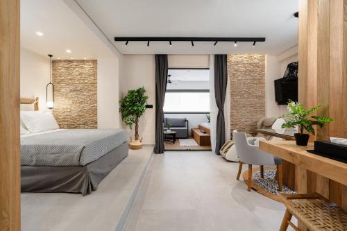 a bedroom with a bed and a living room at Legato Spa Suites in Naxos Chora