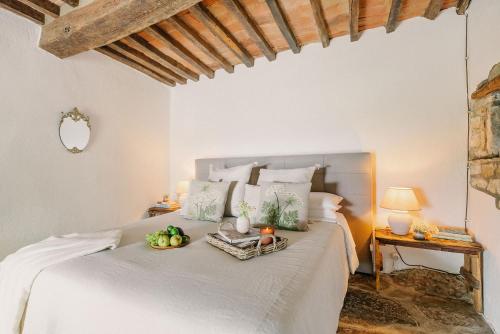 a bedroom with a bed with a tray of fruit on it at Villa Montanare - romantic escape Tuscany in Cortona