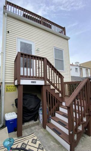 a house with a wooden staircase leading up to a house at Cozy Bay Home Beach+Casino+More in Atlantic City