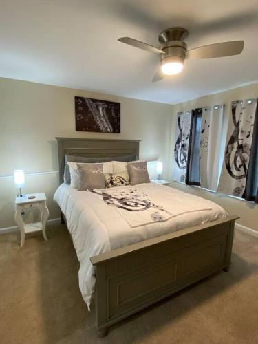 a bedroom with a bed and a ceiling fan at Cozy Bay Home Beach+Casino+More in Atlantic City