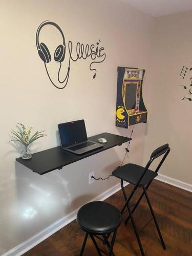 a black desk with a laptop and two chairs at Cozy Bay Home Beach+Casino+More in Atlantic City