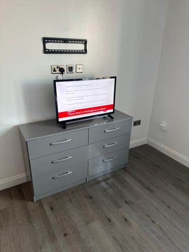 a tv sitting on a dresser in a room at Stunning private room 2 in Bedford