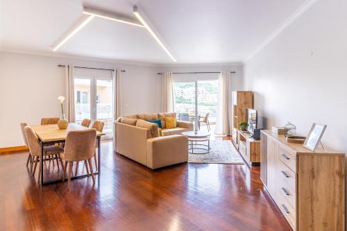 a living room with a couch and a table at Ocean View Flat in Câmara de Lobos