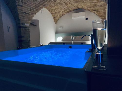a blue tub with a glass of water and a wine glass at B&B Civico 35 in Chieti
