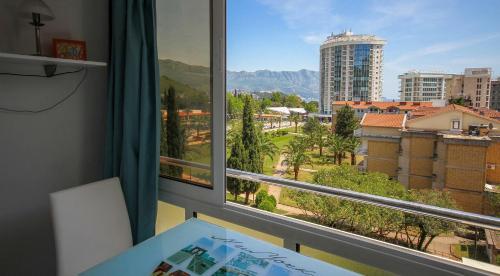 a room with a window with a view of a city at Irena Downtown Apartment in Budva