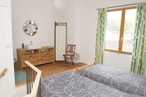 a bedroom with a bed and a desk and a window at Maison avec jardin centre historique in Agde