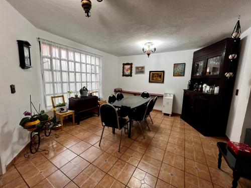 a living room with a dining room table and chairs at Pura Vida! Ciudad Hidalgo in Ciudad Hidalgo