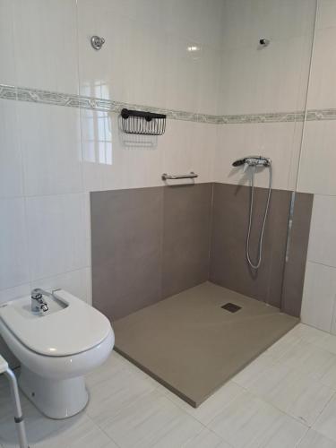 y baño con ducha, aseo y lavamanos. en Casa Arieira, en Cangas de Morrazo