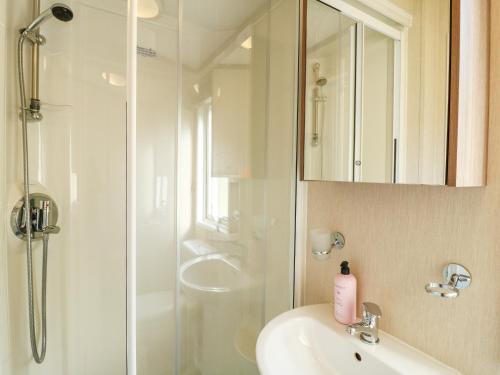 a white bathroom with a shower and a sink at 22 Washbrook Way - Ashbourne Heights in Ashbourne