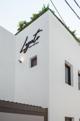 a sign on the side of a white building at Legato Spa Suites in Naxos Chora