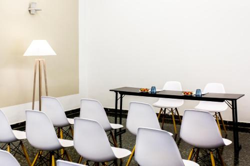 a conference room with a table and chairs at Hotel Pax Guadalajara in Guadalajara