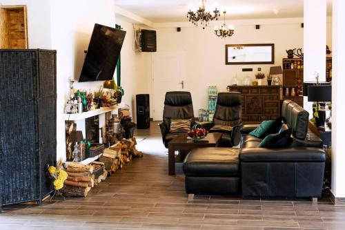 a living room with leather couches and chairs at Agroturystyka Głuchowskie Specjały in Głuchów