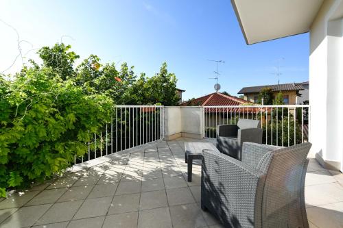 a patio with two chairs and a fence at Hotel Arya by Mauro in Sirmione
