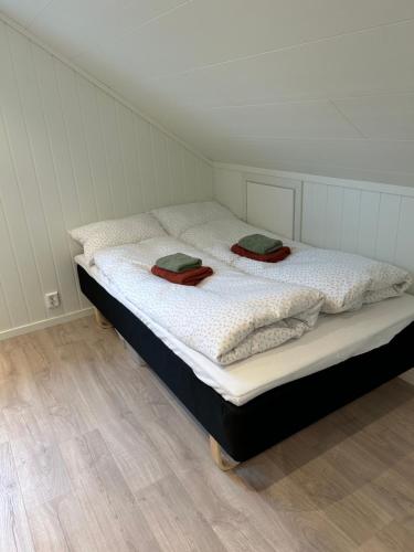 a bedroom with a bed with two towels on it at Fjord apartment 