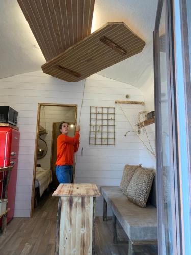 a woman is taking a picture of a room at Le Village de la Champagne - Slowmoov in Bar-sur-Aube