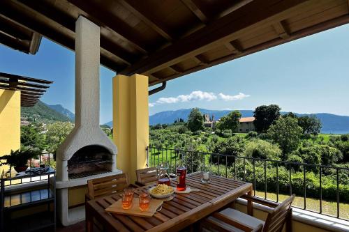 a patio with a fireplace and a table with food at BBQ & Pools GHH in Toscolano Maderno