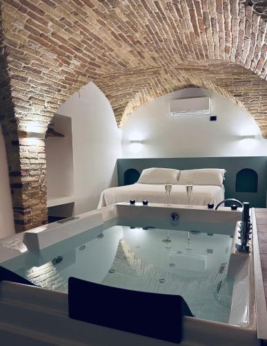 a bedroom with a bed and a tub in a room at B&B Civico 35 in Chieti