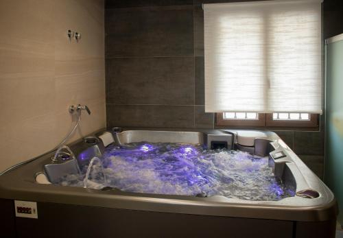 a jacuzzi tub with blue lights in a bathroom at Casa Rural EL RINCON DEL CHEF in Castrojeriz