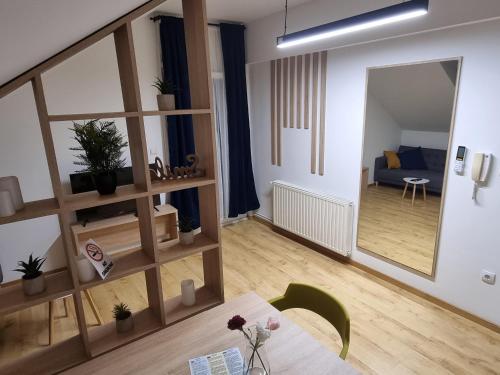 a living room with a table and a mirror at KFN Concept One in Zagreb