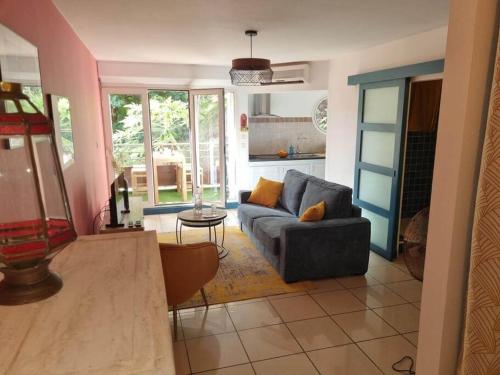 a living room with a couch and a table at Caz'à Boucan in Saint-Gilles les Bains