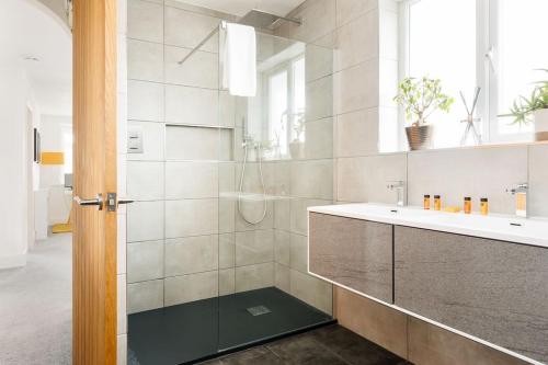 a bathroom with a shower and a sink at Lulworth House in Poole