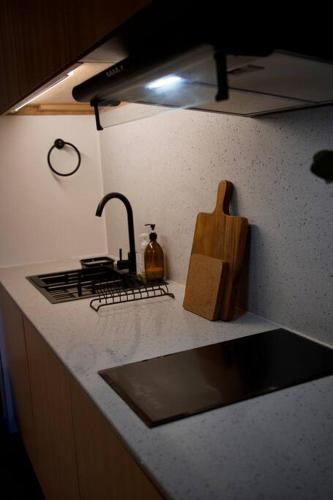 a kitchen counter with a sink and a stove at Nuvali Laguna Amaia 2BR free parking @ The Sanctuary near Tagaytay and Carmelray Industrial Park in Numero Dos