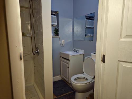 a bathroom with a toilet and a sink and a shower at The Vacay Inn in Lauderdale Lakes