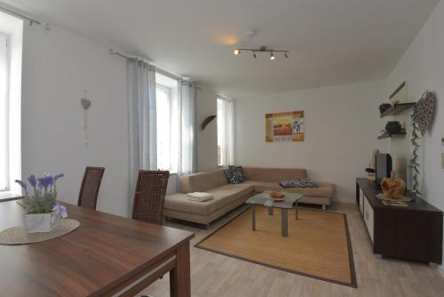 a living room with a couch and a table at Ferienwohnungen Sonneberg in Sonneberg