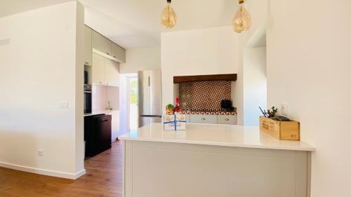 a kitchen with white counters and a white counter top at OceanLand - Santa Cruz in Santa Cruz