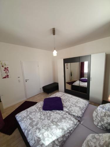 a bedroom with a large bed and a mirror at Ferienwohnungen Sonneberg in Sonneberg