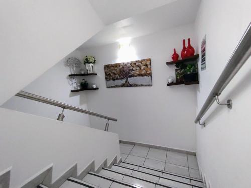 a staircase in a house with white walls and shelves at Posada Del Carmen Aguascalientes in Aguascalientes