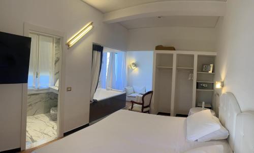 a hotel room with a bed and a bathroom at Eveline 2 - Piscina Privata o Jacuzzi in Sanremo