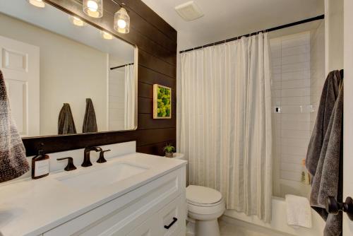 W łazience znajduje się umywalka, toaleta i lustro. w obiekcie Serenity Gardens near the river walk w mieście Boise