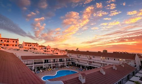 a sunset view of a resort with a swimming pool at Diamond Roof in Los Cristianos